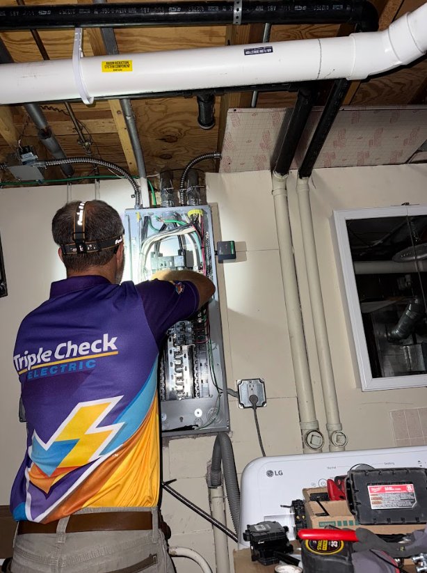 Mike Zagozda wiring an electrical panel during a Triple Check Electric job